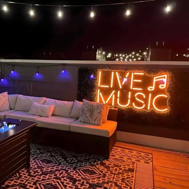 Live Music Custom Neon® sign outdoors on a balcony seating area decorated by @khdesignorders