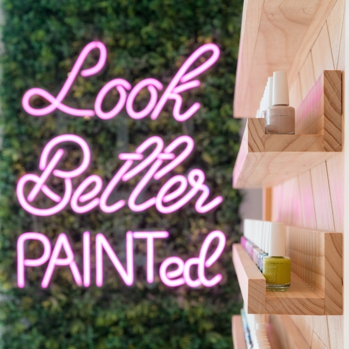 Pink Custom Neon® green wall sign in a nail salon @paintnailbar