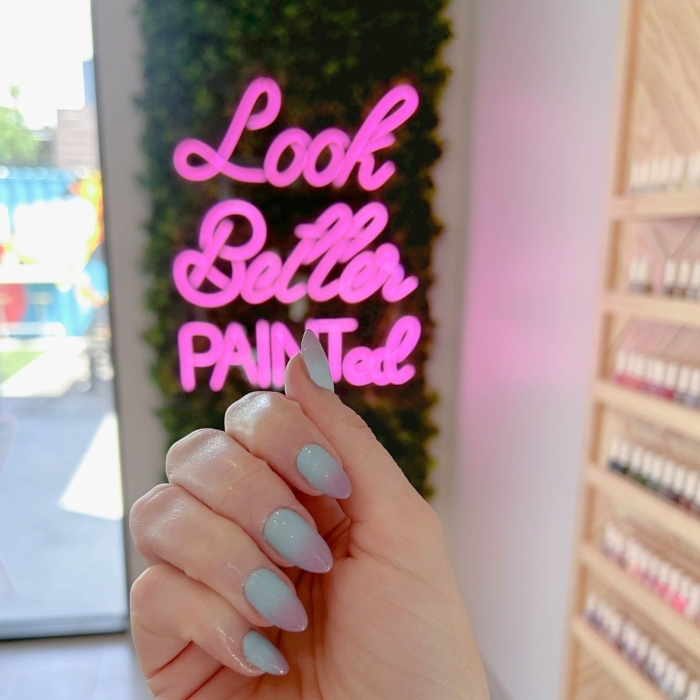 Pink Custom Neon® green wall sign in a nail salon @paintnailbar
