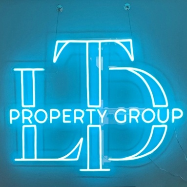 Custom Neon® logo in blue LED neon made for ltd-propertygroup.com
