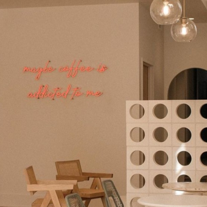 Red Custom Neon® selfie wall sign reading maybe coffee is addicted to me @maydaycoffeeshop