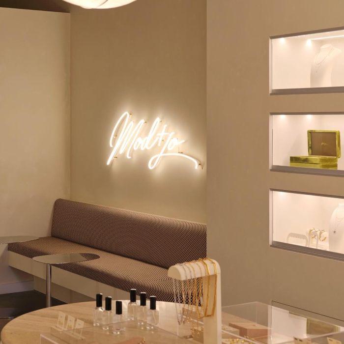 Mod and Jo white script LED neon sign above the seating nook in the brand's Dallas jewelry store