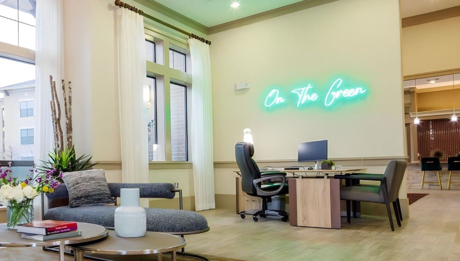 On the Green Custom Neon® sign on a white wall above a desk in a golf club designed by @moderngem_design