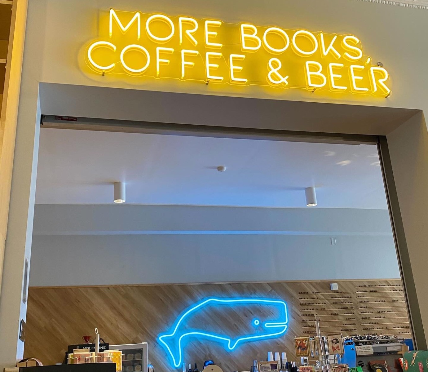 Blue whale neon sign and yellow more books, coffee & beer Custom Neon® retail sign @whitewhalebks
