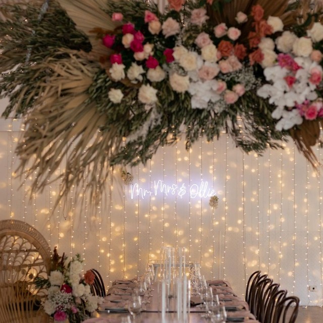 Custom Neon® Mr & Mrs family name sign on a string lights backdrop @jpattersongavin