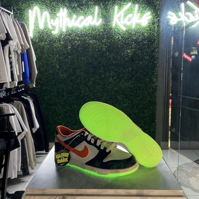 Custom Neon® footware store name sign as with shoes and clothing in the foreground @mythical.kicks