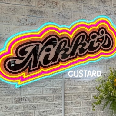Custom Neon® vintage style multi-colored LED neon logo on brick wall