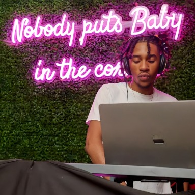 Nobody puts Baby in a corner pink Custom Neon® sign on greenwall behind he DJ @wakefieldcrowbar