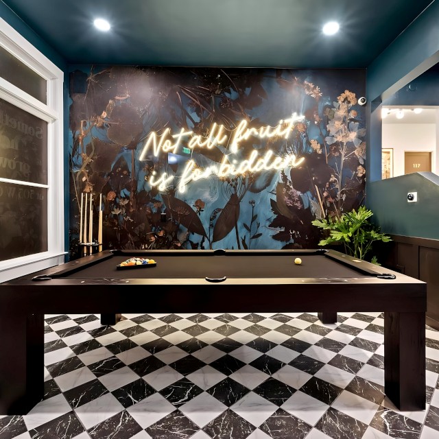 Not all fruit is forbidden warm white Custom Neon® quote a sign on dark blue feature wall in a games room designed by @khdesignorders