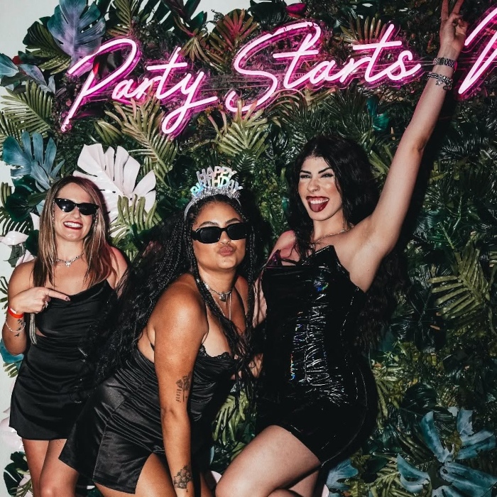Party Starts Now pink Custom Neon® sign on a greenery selfie wall @clevelander