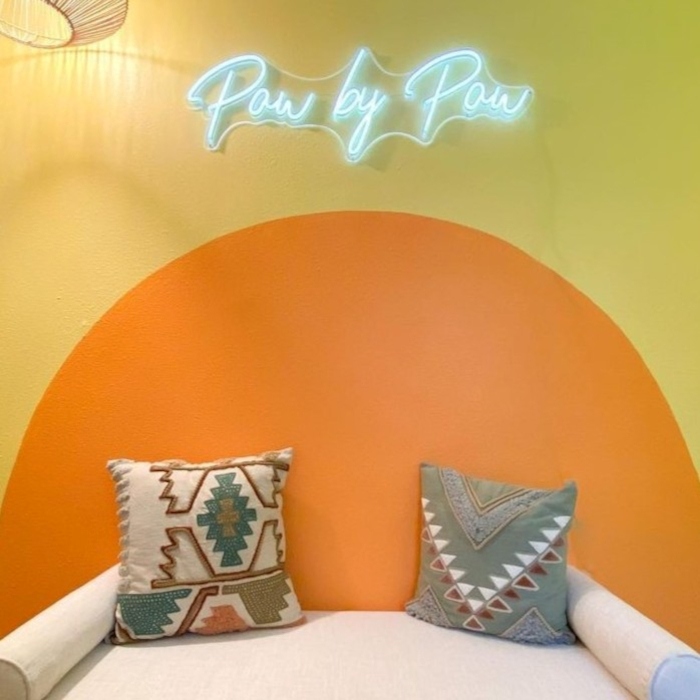 White Custom Neon® dog trainer sign on a bright mural wall @ayumi.pawbypaw