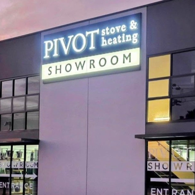 Close up of large front lit channel letters at the top of a double story building at sunset