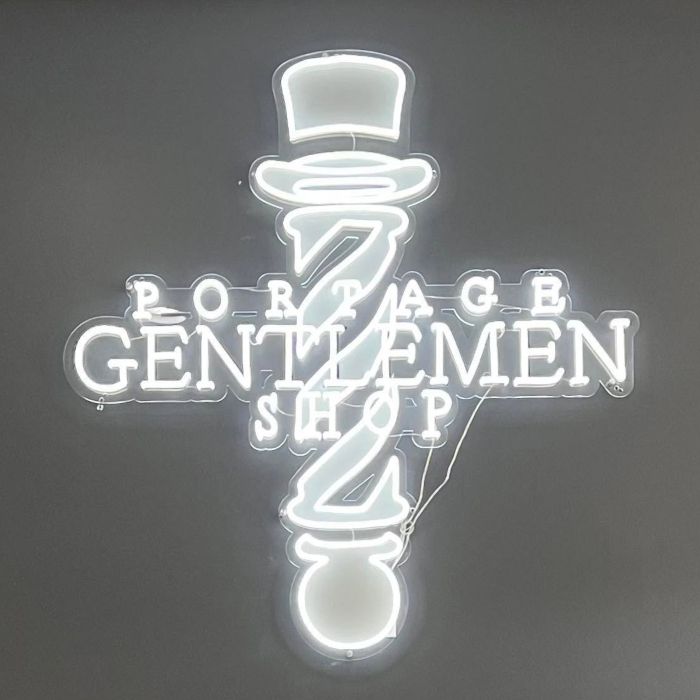 Portage Gentlemen Shop Custom Neon® sign shaped like a barber pole with a top hat