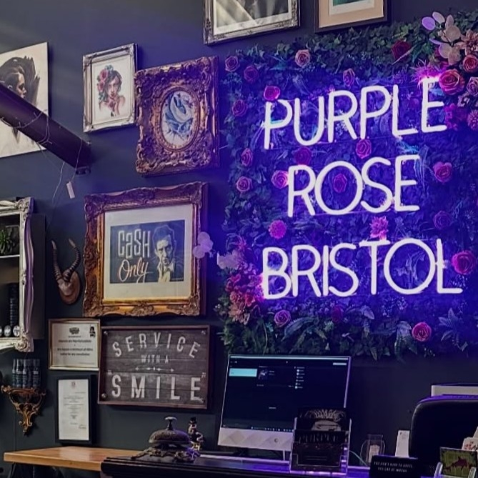 Custom Neon® tattoo parlor name sign in the Purple Rose Tattoo studio
