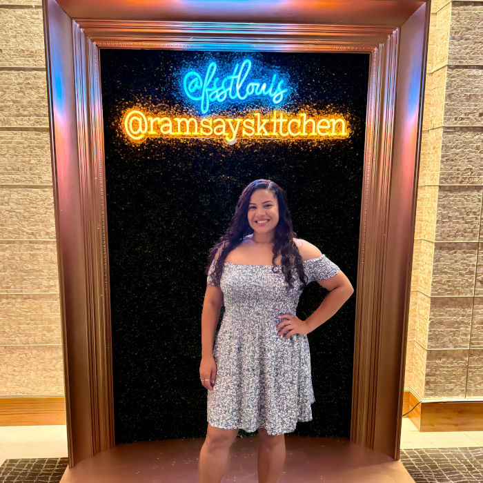 Custom Neon® blue and orange signs reading @fsstlouis @ramsaykitchen in a framed photo wall