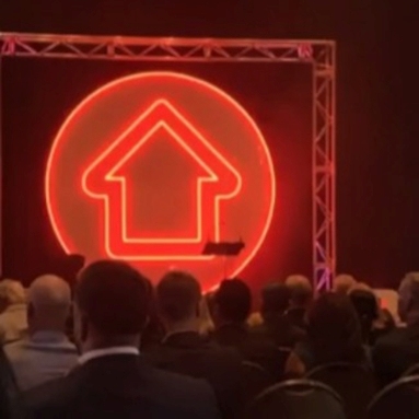 Custom Neon® large red LED neon logo sign made for realestate.com on the stage