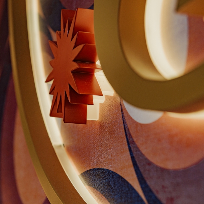 Close up of a gold and red colored stainless steel reverse lit logo made by Custom Neon® in the Golden Days tanning salon