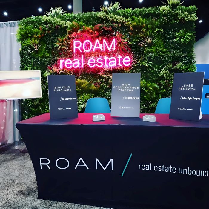 Pink roam real estate Custom Neon® green wall logo sign @roamcommercialrealty 