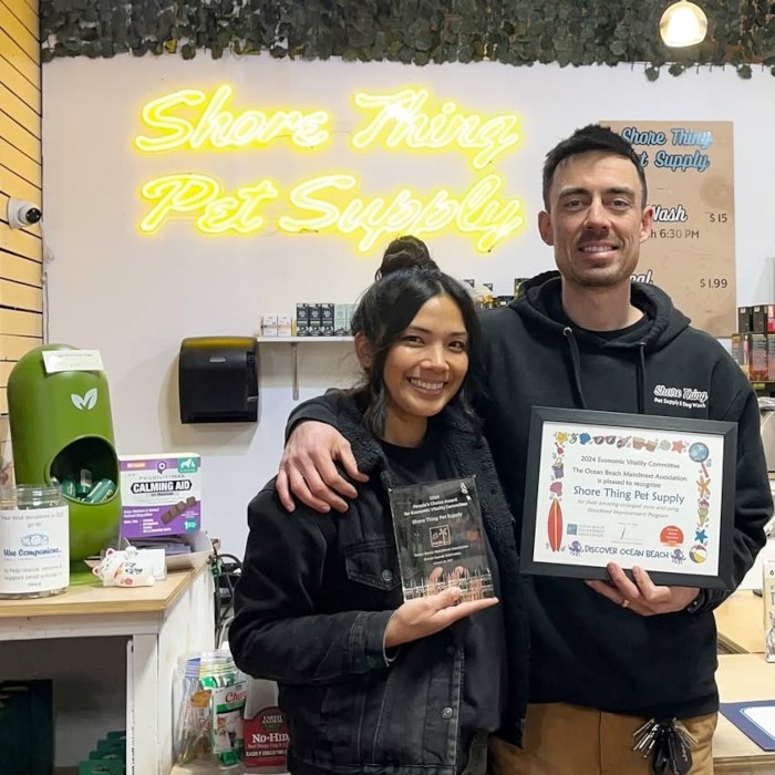 Yellow Custom Neon® pet store sign on a white wall @shorethingpetsupply