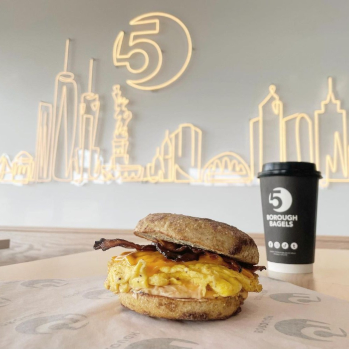 Custom Neon® Large warm white LED neon NYC skyline artwork on a white wall @5boroughbagels