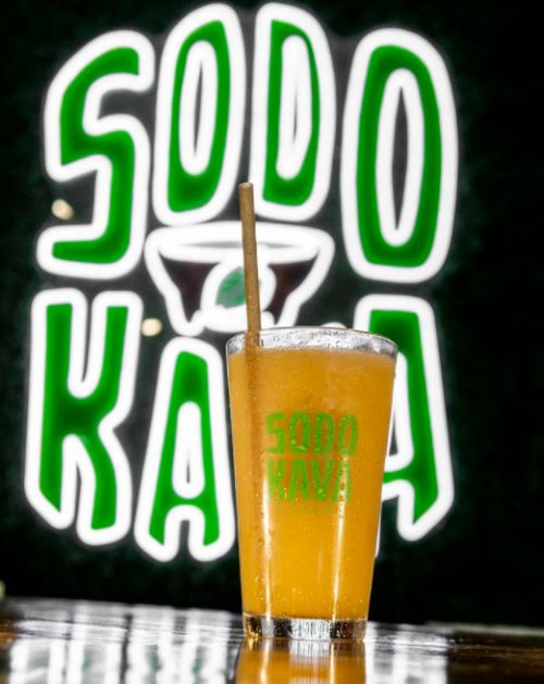 Custom Neon® @sodokava logo with white LED neon flex framing green UV print