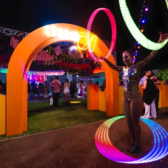 Weatherproof Custom Neon® Studio 54 sign on an arch at the entrance to an open-air corporate event organized by @ultimo_catering