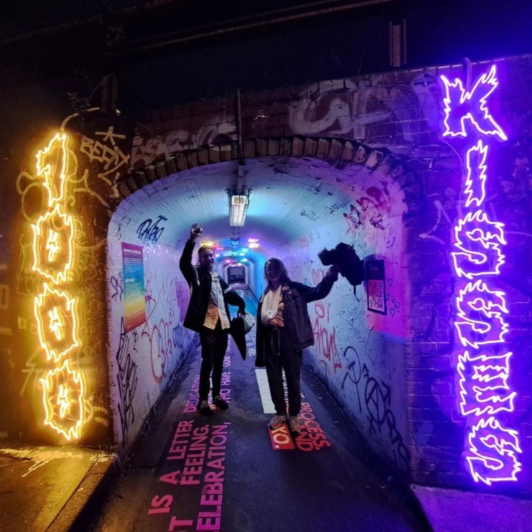 1000 Kisses outdoor neon artwork designed by @k.h.bebe and made by Custom Neon® at the subway underpass entrance