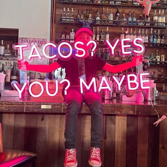Pink Tacos? Yes You? Maybe LED neon sign held up at an Atlanta tequila bar