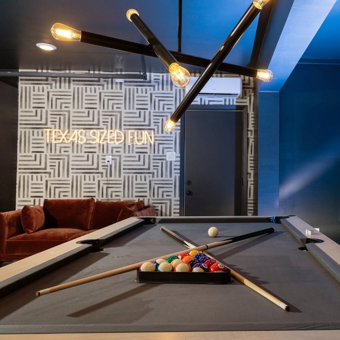 Texas Sized Fun warm white LED Custom Neon® sign in the games room of an Airbnb home designed by Hannah Reid Interiors