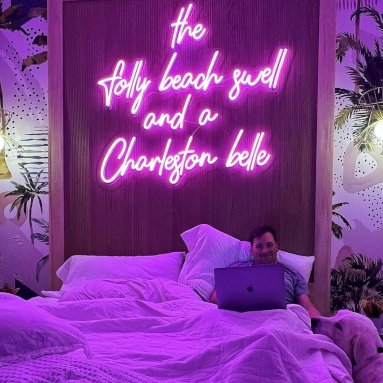 Custom Neon® pink quote sign above the bed in an Airbnb @thejamescharleston