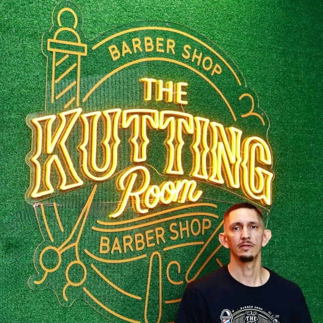 Orange Custom Neon® barbershop logo sign @thekuttingroombarbershop