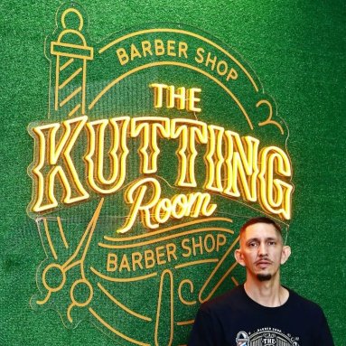 Orange Custom Neon® barbershop logo sign @thekuttingroombarbershop