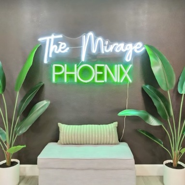 The Mirage Phoenix white and green Custom Neon® sign on the wall in an Airbnb designed by @khdesignorders