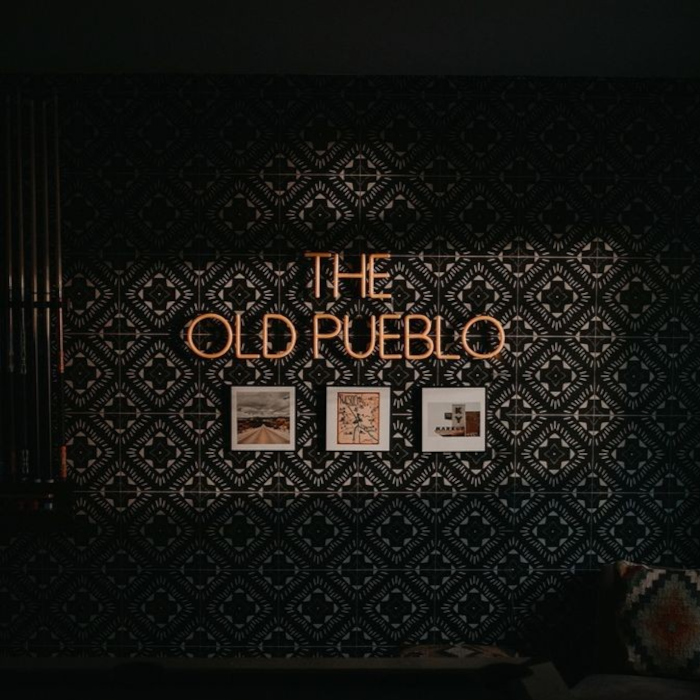 the old pueblo orange LED Custom Neon® games room sign installed on a tiled backdrop in a vacation rental property run by Hometeam Luxury Rentals