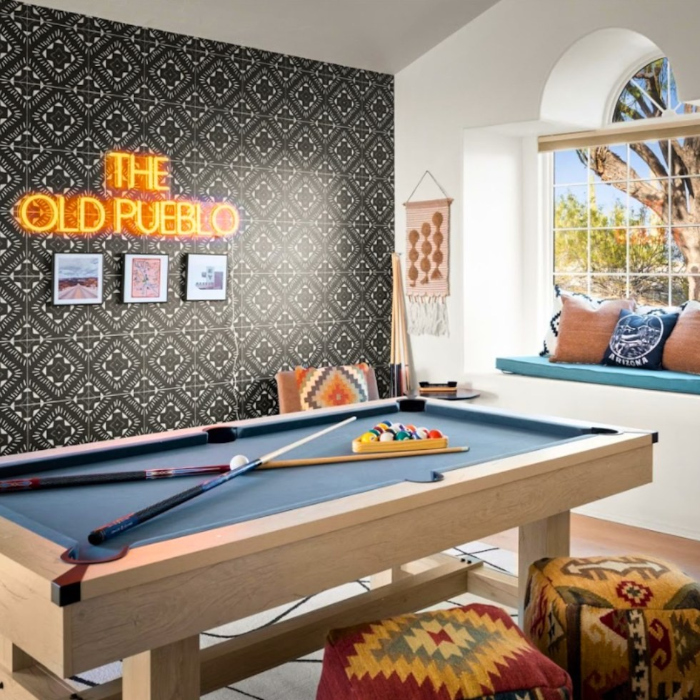 the old pueblo orange LED Custom Neon® games room sign installed on a tiled backdrop in a vacation rental property run by Hometeam Luxury Rentals