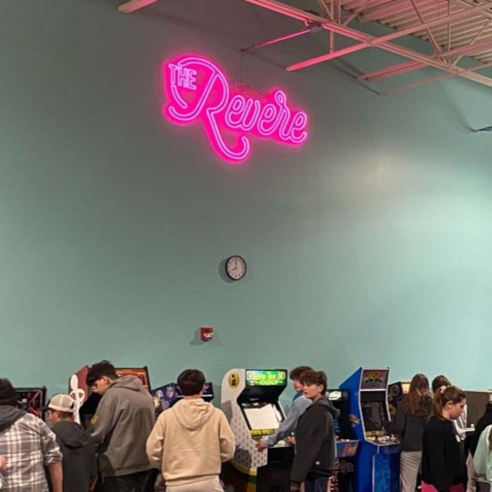 The Revere Custom Neon® sign in pink script above an arcade room at JCC Chicago