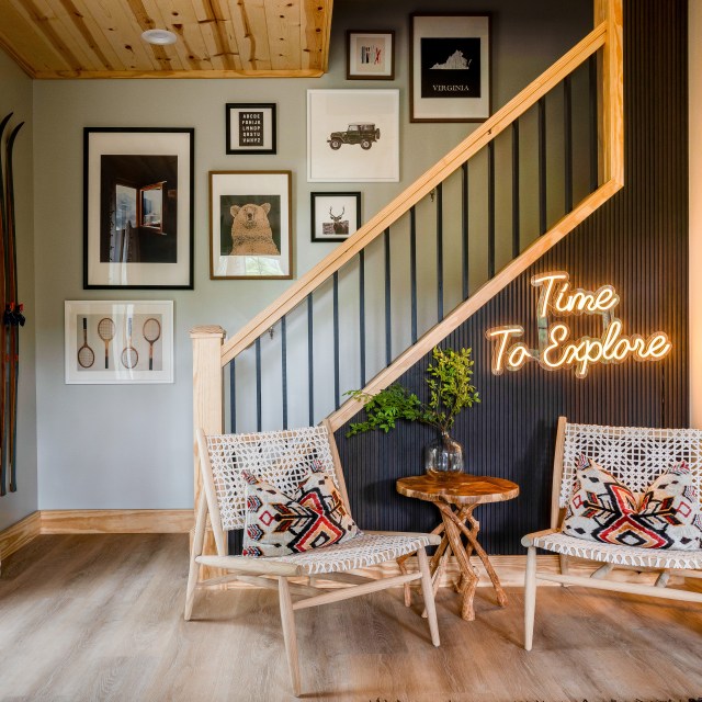 Time to explore Custom Neon® wall sign on a dark wall near the staircase in a short-term rental property decorated by @somerled.designs