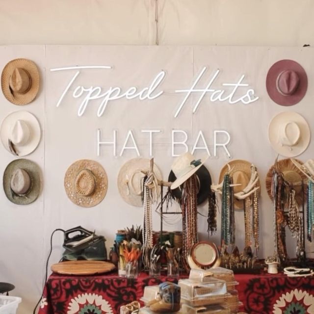 Topped Hats Hat Bar custom white LED neon sign on a hat display wall at a Fort Worth pop-up styling booth