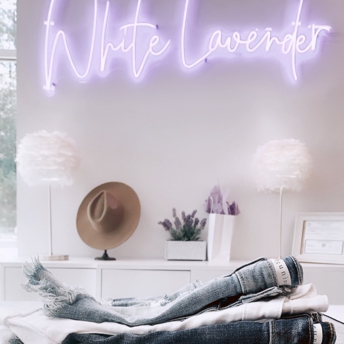 Custom Neon® clothing store name sign in purple LED neon mounted on a white wall @white_lavender_boutique