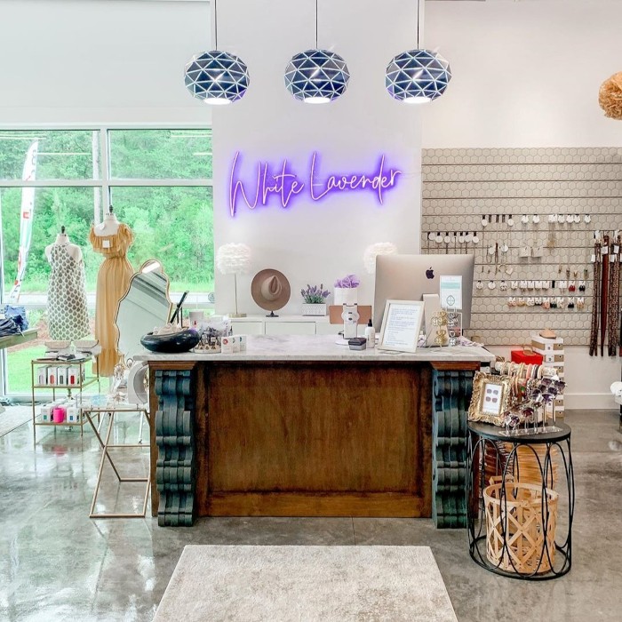 Custom Neon® purple LED neon store name sign on a white wall in the @white_lavender_boutique