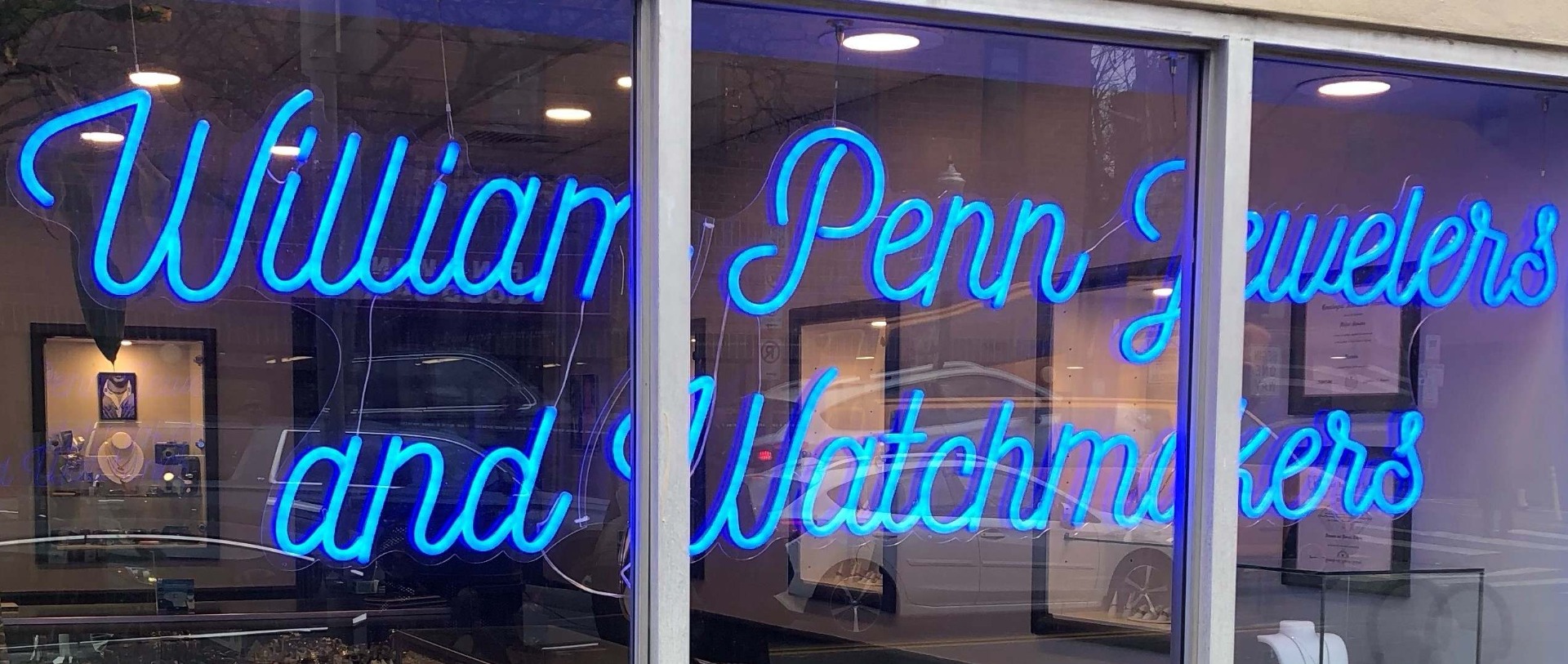 Deep blue Custom Neon® window sign reading William Penn Jewelers and Watchmakers 