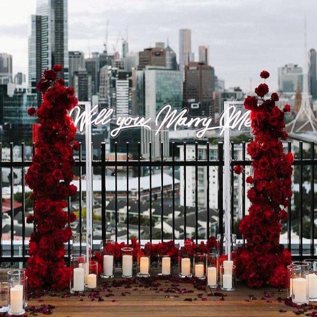 Will you marry me Custom Neon® sign in white LED neon on a balcony overlooking the London skyline @theproposers