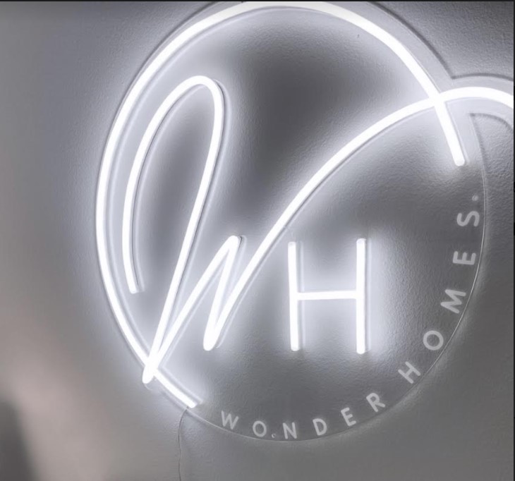 Custom Neon® logo with large initials in white LED neon flex & small text in UV print @wonderhomes