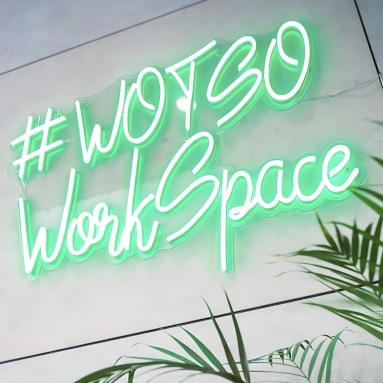 Green Custom Neon® office sign in Barcelona font @wotsoworkspace