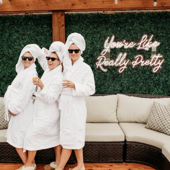 You're Like Really Pretty pink Custom Neon® sign on a greenery wall at @thehavenkc wedding venue