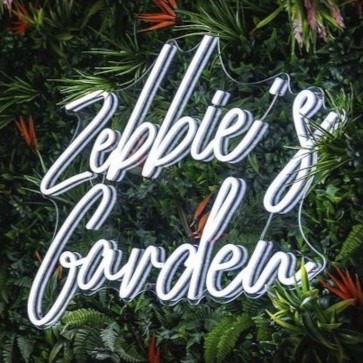 White business name sign on green wall by Custom Neon® @leedesign